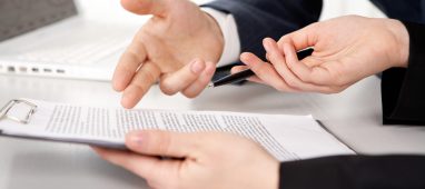 Hands of two businesspeople discussing a contract